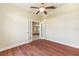 Charming bedroom featuring hardwood flooring, ceiling fan and double doors leading to another room at 6279 Se 8Th Lane, Ocala, FL 34472