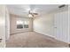 Cozy bedroom with a ceiling fan, carpet flooring, and a window with a view of the outdoors at 6279 Se 8Th Lane, Ocala, FL 34472