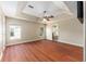 Large bedroom with hardwood flooring, ceiling fan, and tray ceilings at 6279 Se 8Th Lane, Ocala, FL 34472
