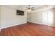 Spacious main bedroom features a ceiling fan, hardwood floors, and closet doors at 6279 Se 8Th Lane, Ocala, FL 34472