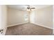 Neutral bedroom with a ceiling fan, carpet flooring, and a window providing natural light at 6279 Se 8Th Lane, Ocala, FL 34472