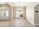 Open dining room showcasing a modern chandelier, arched doorways, and large windows for plenty of light at 6279 Se 8Th Lane, Ocala, FL 34472