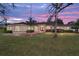 Beautiful single-story home with a well-manicured lawn and charming pink double-door entrance at 6279 Se 8Th Lane, Ocala, FL 34472