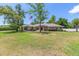 Beautiful home showcasing mature landscaping, a lush green lawn, and a welcoming front entrance at 6279 Se 8Th Lane, Ocala, FL 34472