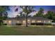 Charming single-story home featuring lush landscaping and a welcoming front entrance at 6279 Se 8Th Lane, Ocala, FL 34472