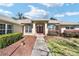 Welcoming entrance featuring a walkway to the front door with pretty, flowering shrubbery at 6279 Se 8Th Lane, Ocala, FL 34472