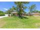 Inviting single-story home with a well-kept lawn, mature trees, and a driveway with adjacent home visible at 6279 Se 8Th Lane, Ocala, FL 34472