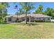 Charming single-story home with a well-manicured lawn, mature trees, and manicured landscaping at 6279 Se 8Th Lane, Ocala, FL 34472
