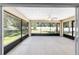 Covered screened lanai overlooking the green backyard, offering a ceiling fan for additional comfort at 6279 Se 8Th Lane, Ocala, FL 34472