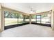 Screened-in lanai features a ceiling fan and views of the backyard, providing a relaxing outdoor space at 6279 Se 8Th Lane, Ocala, FL 34472