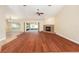 Bright living room with hardwood floors, fireplace, and sliding doors to the patio at 6279 Se 8Th Lane, Ocala, FL 34472