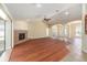 Open living room features arched doorways, hardwood floors, and gas fireplace at 6279 Se 8Th Lane, Ocala, FL 34472