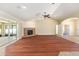 Open living room features vaulted ceiling, hardwood floors, and gas fireplace at 6279 Se 8Th Lane, Ocala, FL 34472