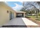 View of the screened-in lanai and patio overlooking the backyard, with white vinyl fence at 6279 Se 8Th Lane, Ocala, FL 34472