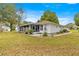 Landscaped backyard with a screened patio, a perfect spot for enjoying outdoors at 6450 Sw 83Rd Ln, Ocala, FL 34476