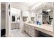 Bathroom featuring double sinks, a large mirror and vanity at 6450 Sw 83Rd Ln, Ocala, FL 34476