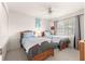 Charming bedroom featuring two twin beds, a ceiling fan, and a bright window at 6450 Sw 83Rd Ln, Ocala, FL 34476