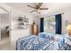 Bright bedroom featuring two twin beds with stylish blue bedding and a ceiling fan at 6450 Sw 83Rd Ln, Ocala, FL 34476