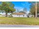 Charming home with a well-maintained lawn, mature trees, and a serene suburban setting at 6450 Sw 83Rd Ln, Ocala, FL 34476