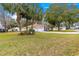 Charming home with mature palm trees, well-manicured lawn, and inviting front yard at 6450 Sw 83Rd Ln, Ocala, FL 34476