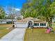 Inviting single-story home with a well-maintained lawn, two-car garage, and decorative driveway at 6450 Sw 83Rd Ln, Ocala, FL 34476