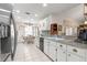 Modern kitchen featuring granite countertops, a stainless steel sink, and white cabinets at 6450 Sw 83Rd Ln, Ocala, FL 34476