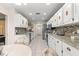 Bright eat-in kitchen featuring granite countertops, white cabinetry, and modern appliances at 6450 Sw 83Rd Ln, Ocala, FL 34476