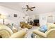 Comfortable living room with plush furnishings, ceiling fan, and seamless transition to other living spaces at 6450 Sw 83Rd Ln, Ocala, FL 34476