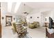A spacious living room with vaulted ceilings and neutral tones, showcasing ample seating options at 6450 Sw 83Rd Ln, Ocala, FL 34476