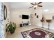 Comfortable living room featuring tile flooring, a large flat screen TV, and access to the breakfast bar at 7053 Sw 131St Loop, Ocala, FL 34473