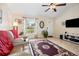 Inviting living room with neutral colors, large window, tile flooring, and comfortable seating at 7053 Sw 131St Loop, Ocala, FL 34473