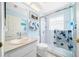 Bathroom features white fixtures, glass shower and blue accents throughout at 7178 Sw 113Th Loop, Ocala, FL 34476
