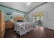 Comfortable bedroom with hardwood floors, updated ceiling fan and sliding glass door at 7178 Sw 113Th Loop, Ocala, FL 34476