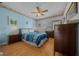 Comfortable bedroom with bright blue walls, laminate flooring, and a view from the window at 7178 Sw 113Th Loop, Ocala, FL 34476