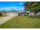 Charming home featuring a well-manicured lawn, a spacious driveway, and an attached two-car garage at 7178 Sw 113Th Loop, Ocala, FL 34476