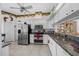 Bright kitchen features stainless steel appliances, granite countertops, and white cabinets at 7178 Sw 113Th Loop, Ocala, FL 34476