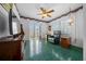 Bright living room with tiled floors, patio doors, and a comfortable green armchair at 7178 Sw 113Th Loop, Ocala, FL 34476