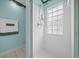 Shower features white tile and glass block window and a rainfall shower head at 7178 Sw 113Th Loop, Ocala, FL 34476