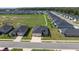 Overhead view of a residential street with manicured lawns and community green at 7374 Sw 77Th Ave, Ocala, FL 34481