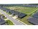 Aerial view of a home with a well-manicured lawn and a community green space at 7374 Sw 77Th Ave, Ocala, FL 34481