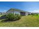 View of the backyard with a screened-in porch and lush green lawn at 7374 Sw 77Th Ave, Ocala, FL 34481