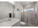 Modern bathroom with a glass-enclosed shower, a gray tiled wall, and a marble countertop at 7374 Sw 77Th Ave, Ocala, FL 34481