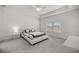 Spacious bedroom with a tray ceiling, large windows, carpet, and modern furniture at 7374 Sw 77Th Ave, Ocala, FL 34481