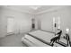Bright bedroom featuring a tray ceiling, walk-in closet, and ensuite bathroom at 7374 Sw 77Th Ave, Ocala, FL 34481