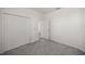 Clean bedroom with neutral carpet and a closet behind double doors at 7374 Sw 77Th Ave, Ocala, FL 34481