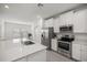 Stylish kitchen featuring stainless steel appliances, white cabinets, and ample counter space at 7374 Sw 77Th Ave, Ocala, FL 34481
