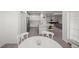 Open-concept kitchen with white cabinetry, stainless steel appliances, and breakfast bar overlooking the game room at 7374 Sw 77Th Ave, Ocala, FL 34481