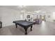 Open-concept living room featuring bright, neutral paint, tile floors, and tray ceiling at 7374 Sw 77Th Ave, Ocala, FL 34481