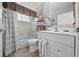 Cozy bathroom featuring tiled shower, white vanity, and wood-look flooring at 8382 Sw 109Th Lane Rd, Ocala, FL 34481