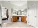 Bright bathroom with double sinks, mirrors, and tiled flooring at 8782 Sw 82Nd Court Rd, Ocala, FL 34481
